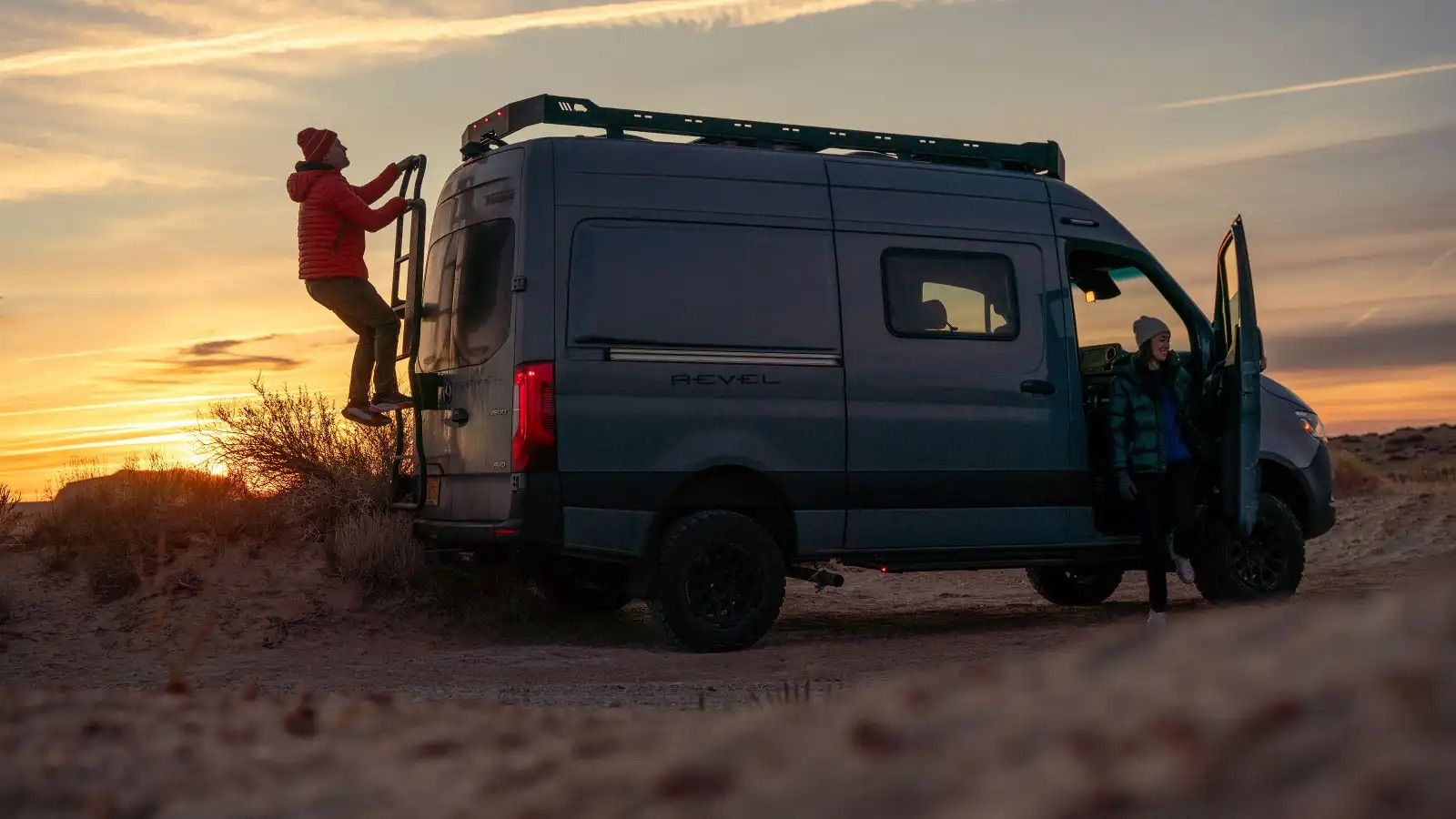 Winnebago on a dusty desert road at sunset
