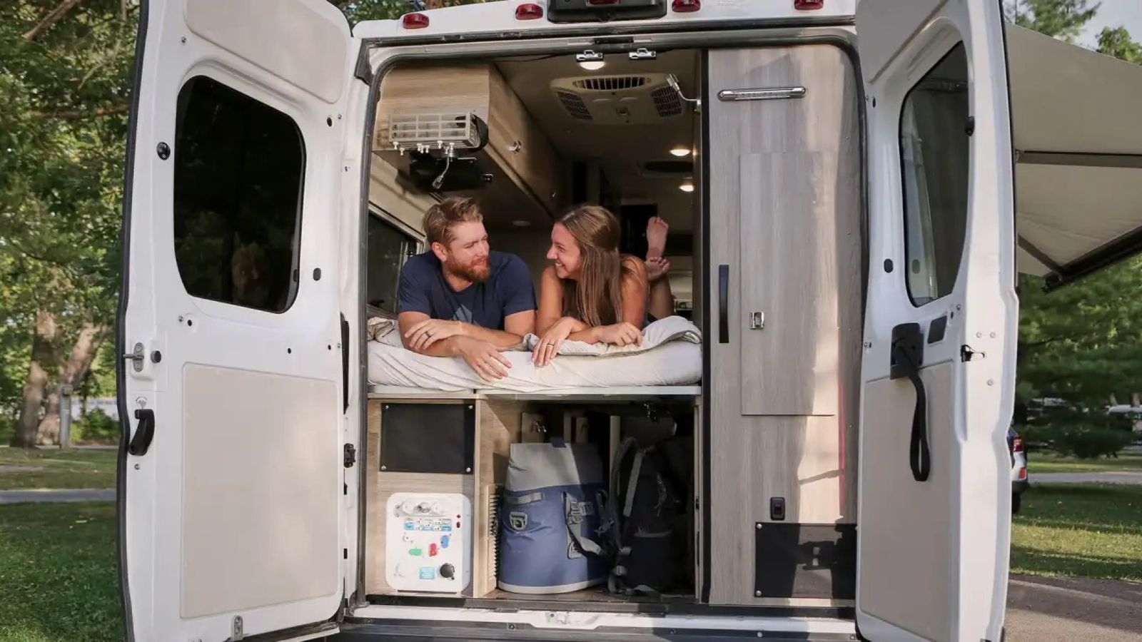 Couple inside the back of the Winnebago Travato