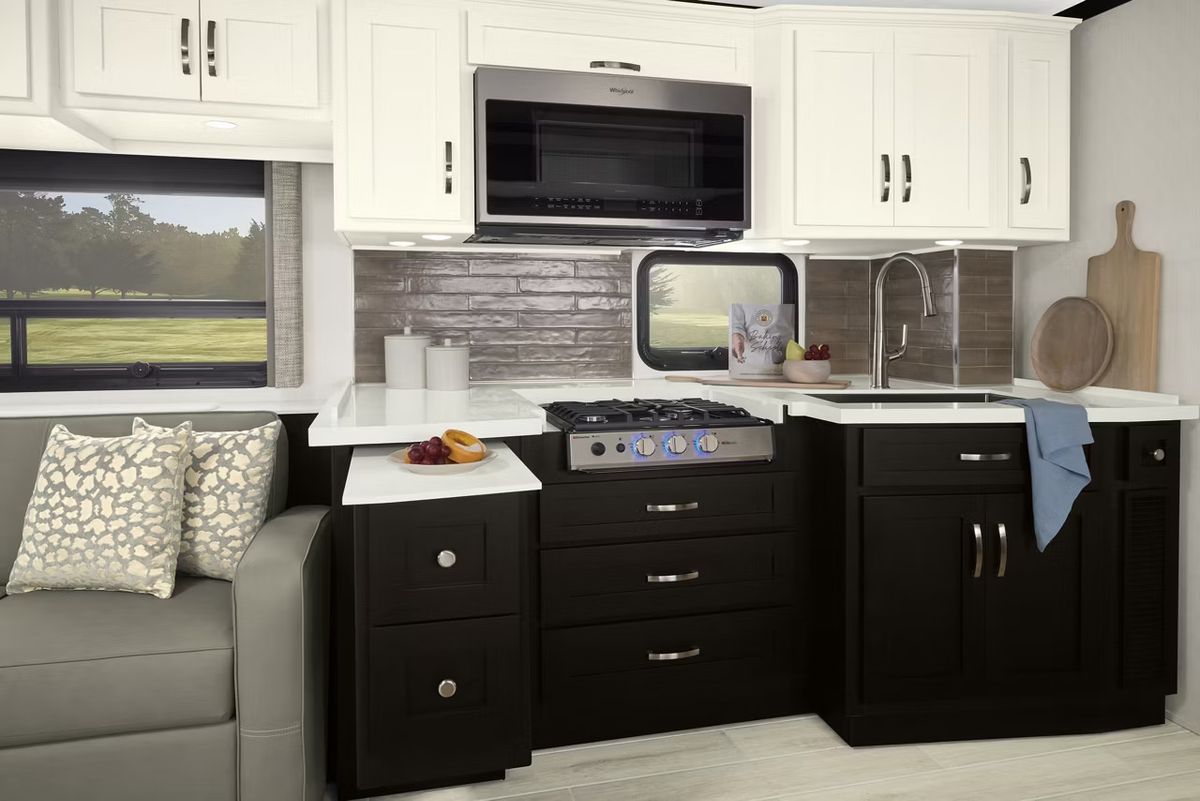 Black cabinets inside an RV kitchen