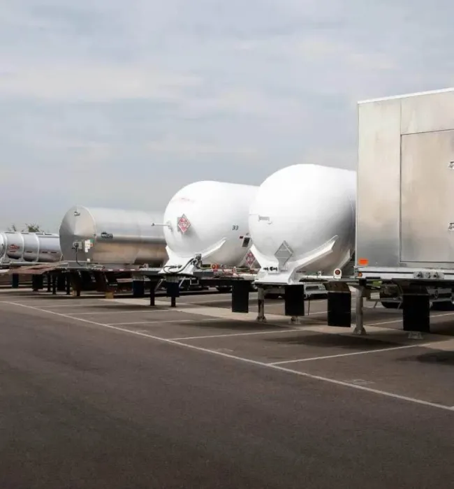 A row of unhitched trailers in a parking lot